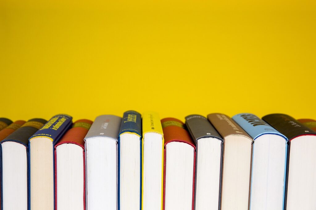 A horizontal row of books against a yellow background