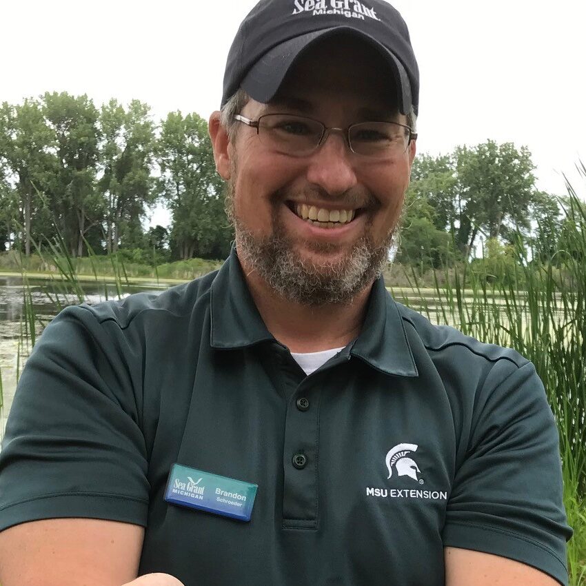 Portrait of Brandon Schroeder holding a Bowfin fish