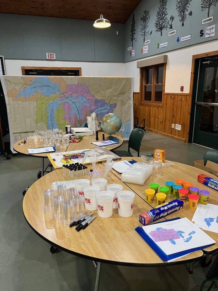 Supplies - including a Great Lakes basin map and other hands-on items - set up to explore water's role in earth systems
