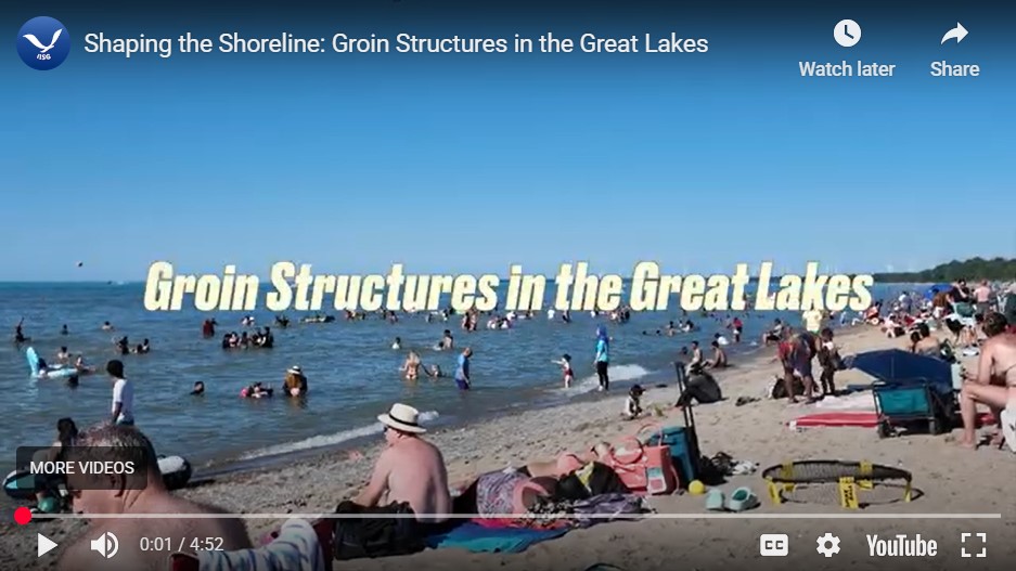 A photo of the beach, crowded with beachgoers. The title "Groin Structures in the Great Lakes" is displayed across the center of the photo.