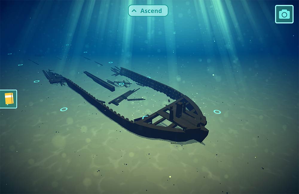 Screenshot of the game featuring an underwater illustration of a shipwreck sitting on a sandy lakebed with sand covering part of the vessel. There are multiple buttons including a book, ascend option, and camera.
